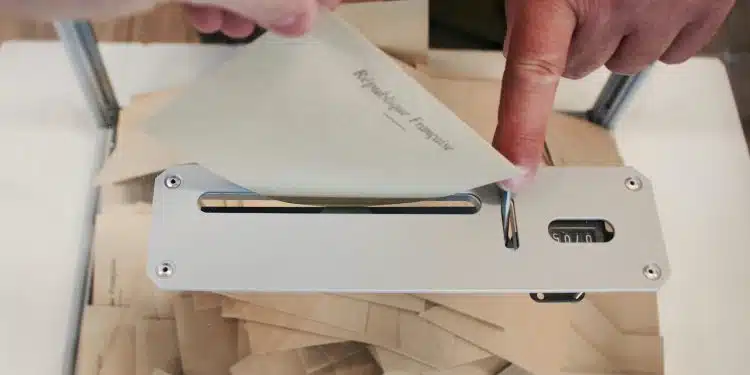 person holding white machine on top of white table